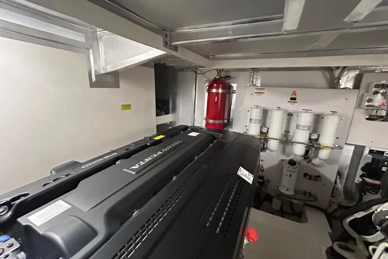  Yacht Photos Pics Engine room of 2020 Maritimo M64 yacht with Volvo Penta engine and fire extinguisher.