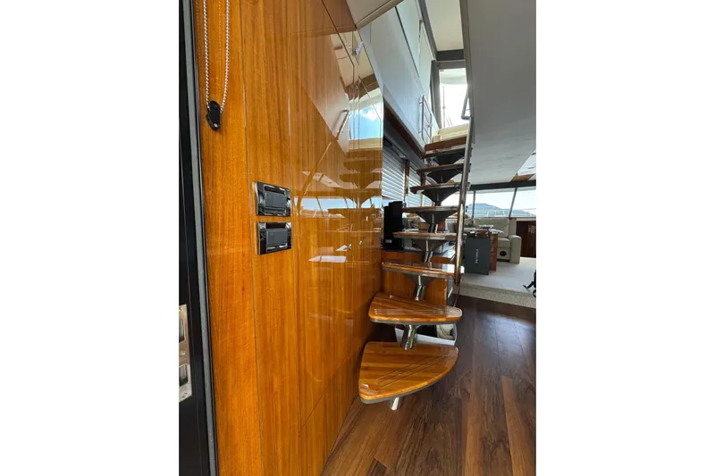  Yacht Photos Pics Luxurious wooden staircase inside 2020 Maritimo M64 yacht, featuring sleek design and modern interior.