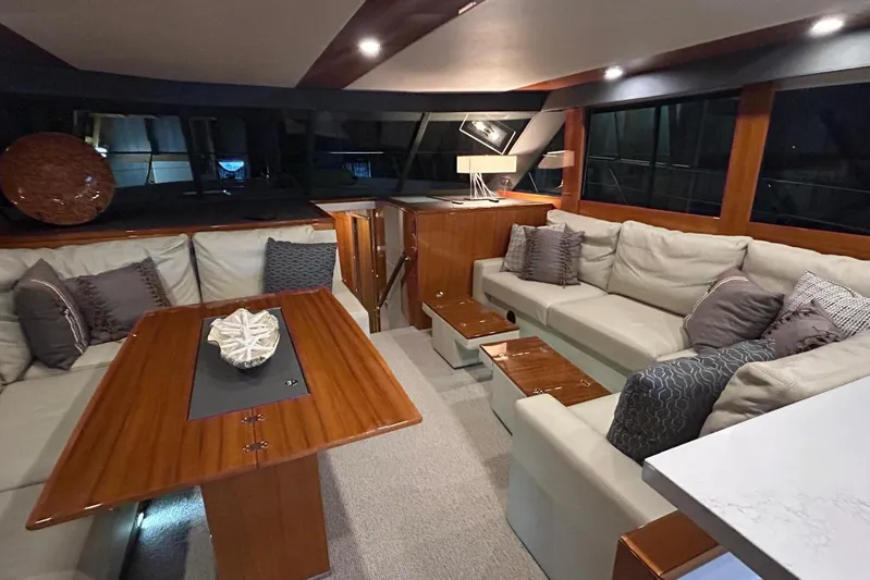  Yacht Photos Pics Luxurious interior of 2020 Maritimo M64 yacht with elegant seating and wooden accents.