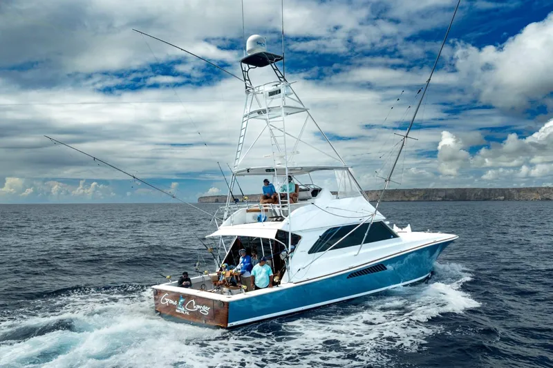  Yacht Photos Pics 2002 Viking 55 Convertible yacht cruising on open ocean under cloudy sky.