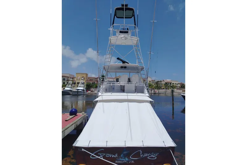  Yacht Photos Pics 2002 Viking 55 Convertible yacht docked in a marina under a clear blue sky.