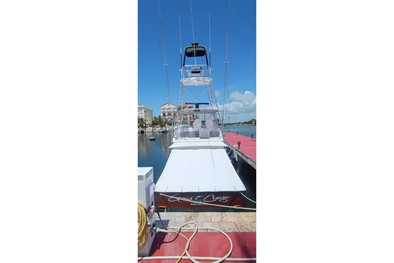  Yacht Photos Pics 2002 Viking 55 Convertible yacht docked at marina under clear blue sky.