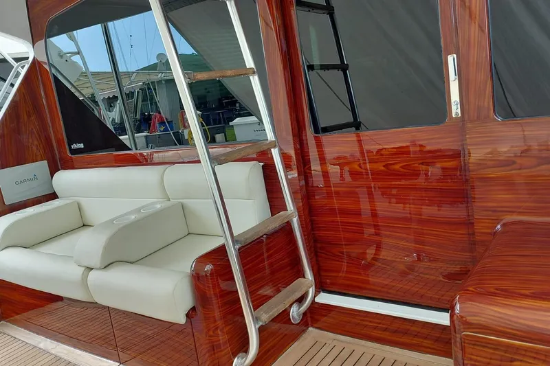  Yacht Photos Pics Luxurious interior of 2002 Viking 55 Convertible yacht with polished wood and white seating.