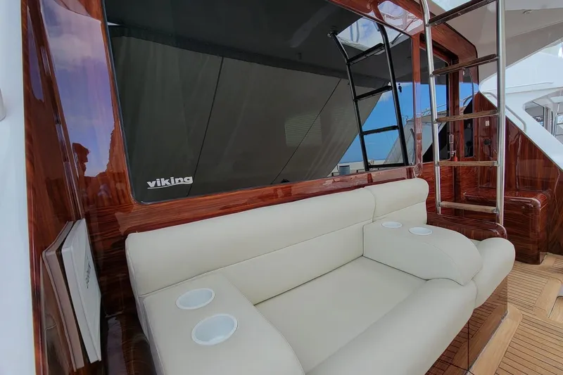  Yacht Photos Pics Luxurious interior of 2002 Viking 55 Convertible yacht with cream sofa and wooden accents.