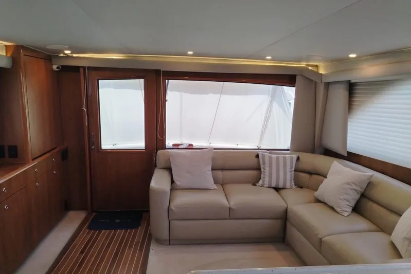  Yacht Photos Pics Luxurious interior of a 2002 Viking 55 Convertible yacht with plush seating and elegant wood finishes.