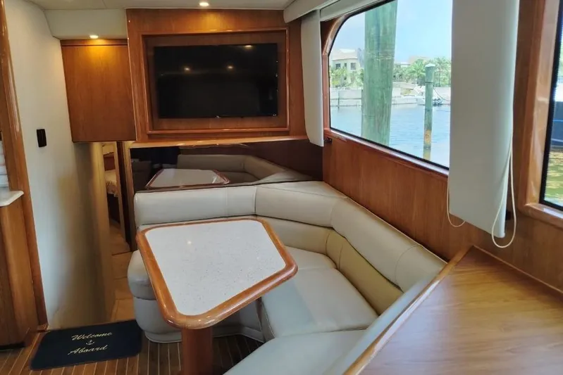  Yacht Photos Pics Interior of 2002 Viking 55 Convertible yacht with cozy seating and TV.