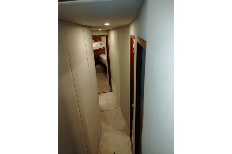  Yacht Photos Pics Narrow hallway inside 2002 Viking 55 Convertible yacht, leading to a bedroom.