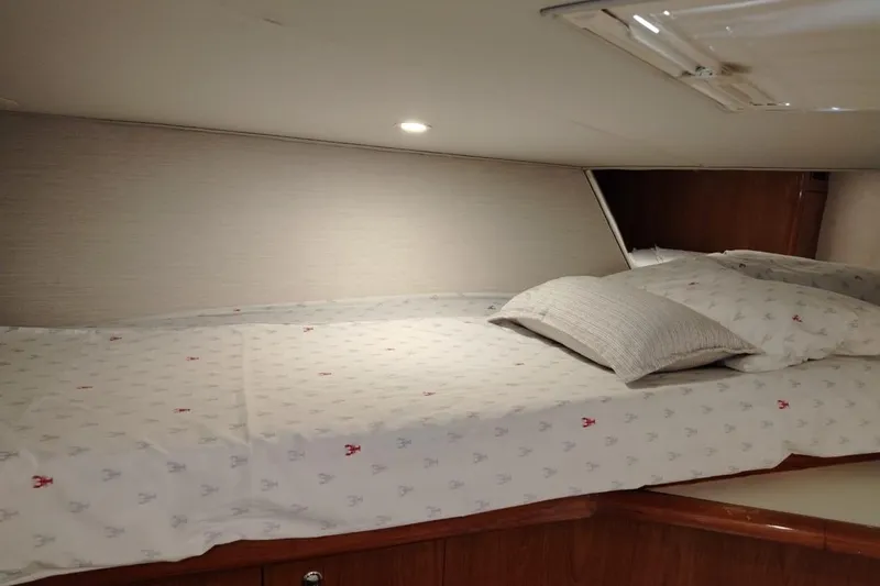  Yacht Photos Pics Cozy cabin bed in 2002 Viking 55 Convertible yacht interior.