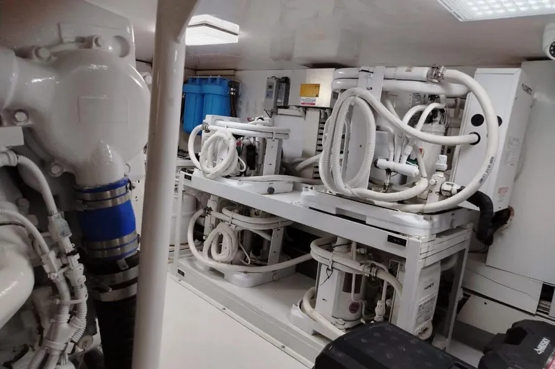  Yacht Photos Pics Engine room of a 2002 Viking 55 Convertible yacht, featuring complex machinery and piping.