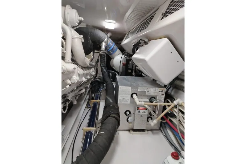  Yacht Photos Pics Engine room of 2002 Viking 55 Convertible yacht, showcasing machinery and piping.