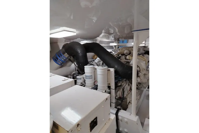  Yacht Photos Pics Engine room of a 2002 Viking 55 Convertible yacht, showcasing mechanical components.