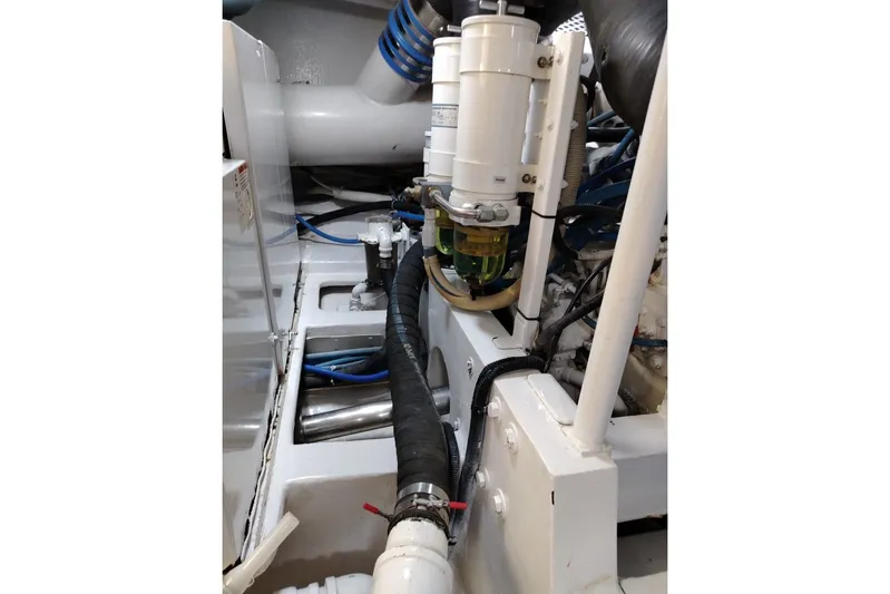  Yacht Photos Pics Engine room of 2002 Viking 55 Convertible yacht, showcasing mechanical components and hoses.