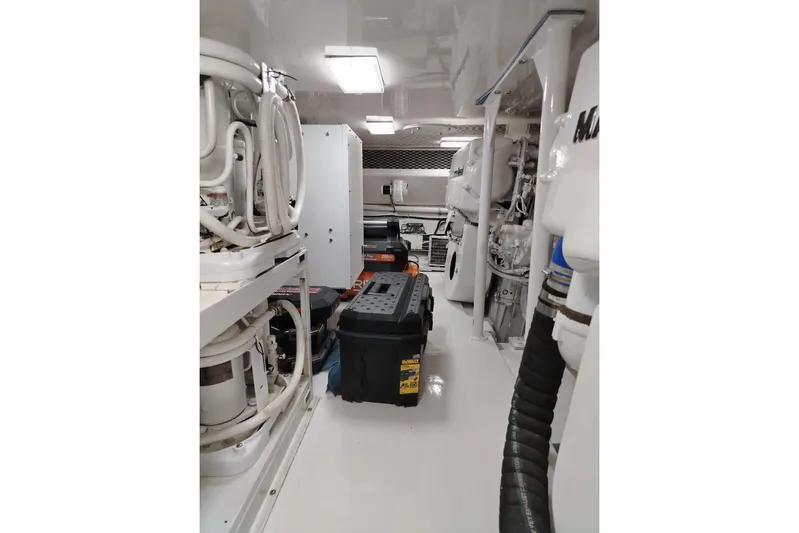  Yacht Photos Pics Engine room of 2002 Viking 55 Convertible yacht with equipment and tools.