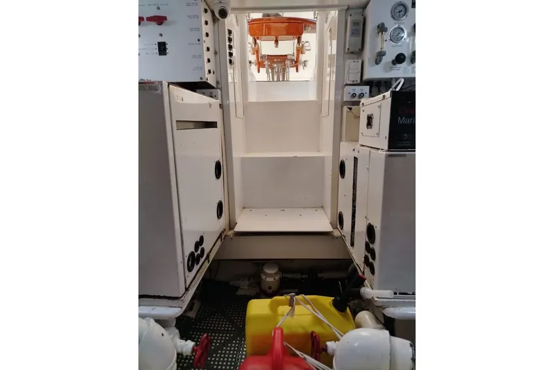  Yacht Photos Pics Engine room of a 2002 Viking 55 Convertible yacht with control panels and equipment.