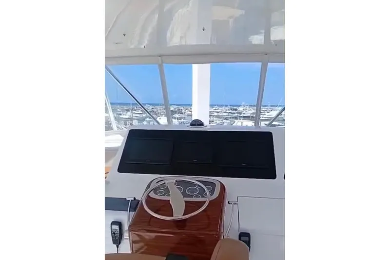  Yacht Photos Pics Helm of 2002 Viking 55 Convertible yacht with ocean view in background.