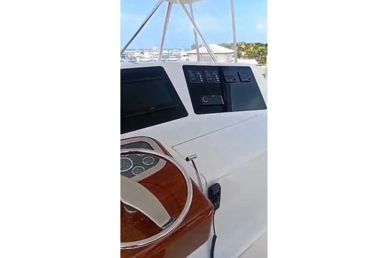  Yacht Photos Pics Helm of 2002 Viking 55 Convertible yacht with steering wheel and control panel.