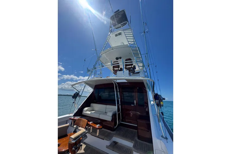  Yacht Photos Pics 2002 Viking 55 Convertible yacht with tower, ocean view, and sunny sky.