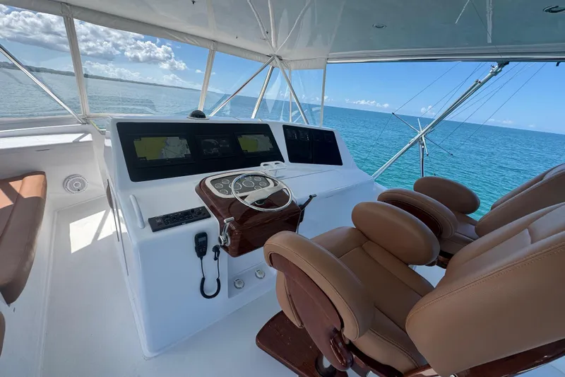  Yacht Photos Pics 2002 Viking 55 Convertible yacht helm with ocean view and navigation equipment.