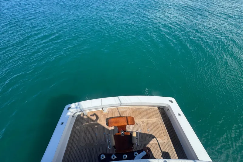  Yacht Photos Pics 2002 Viking 55 Convertible yacht deck overlooking clear blue ocean waters.