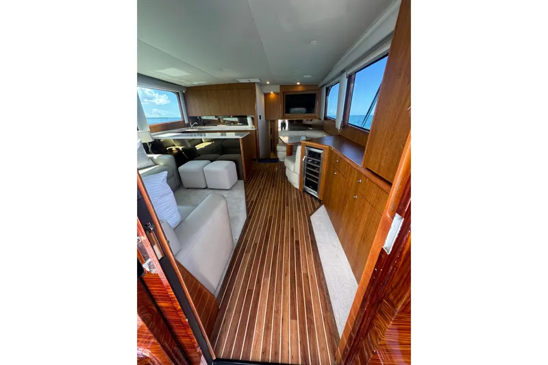  Yacht Photos Pics Luxurious interior of 2002 Viking 55 Convertible yacht with wood flooring and modern furnishings.
