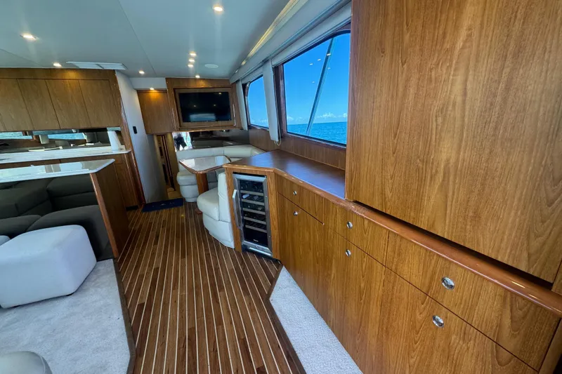  Yacht Photos Pics Luxurious interior of 2002 Viking 55 Convertible yacht with wood finishes and ocean view.