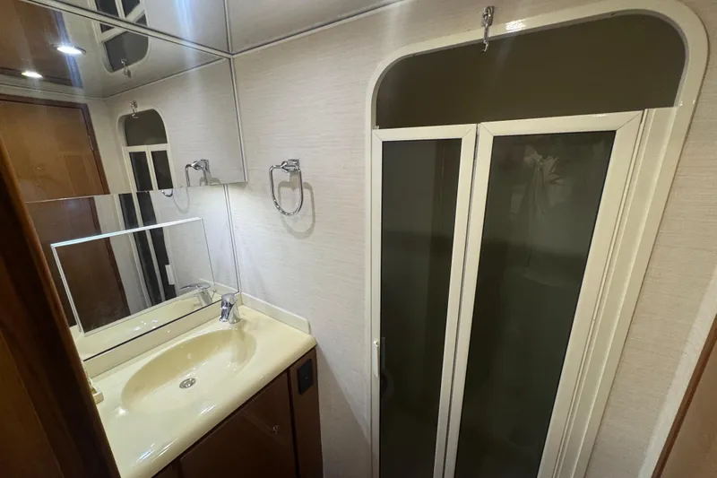  Yacht Photos Pics Bathroom interior of 2002 Viking 55 Convertible yacht with sink and shower.
