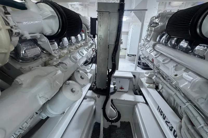  Yacht Photos Pics Engine room of 2002 Viking 55 Convertible yacht, showcasing dual engines and mechanical components.