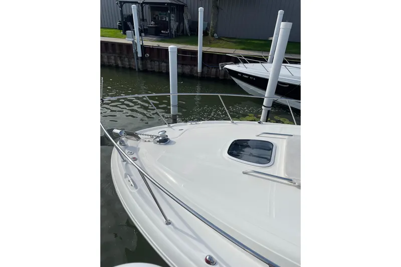  Yacht Photos Pics 2007 Sea Ray 340 Sundancer docked, showcasing sleek bow design and water reflections.