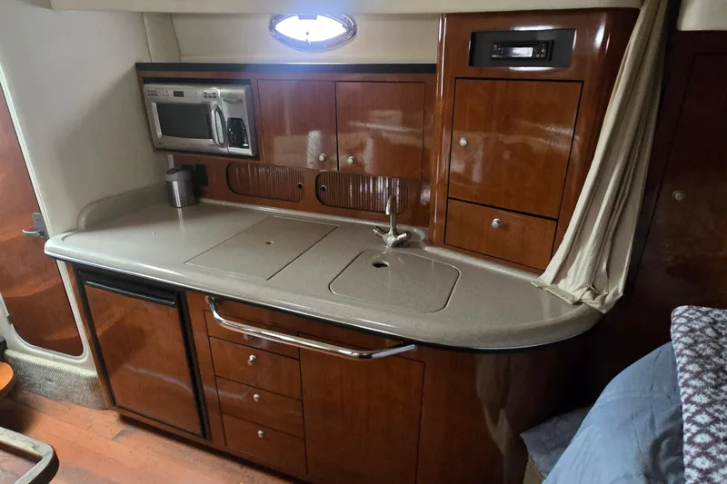  Yacht Photos Pics 2007 Sea Ray 340 Sundancer galley with wood cabinetry and modern appliances.