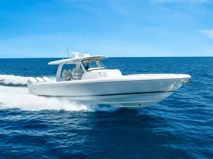  Yacht Photos Pics 2026 Intrepid 43 Nomad SE cruising on open ocean under clear blue sky.