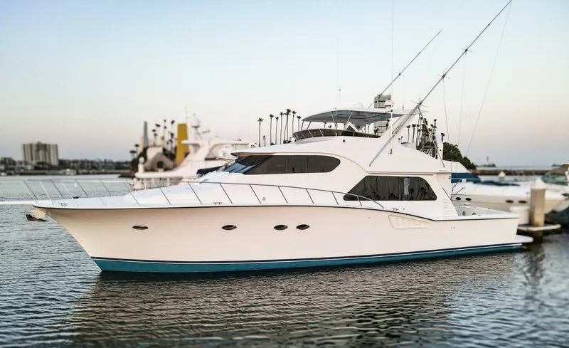 Ok'd By Dad Yacht Photos Pics 2001 Mikelson 61 Yachtfisher in marina, sleek design, calm water, sunset backdrop.