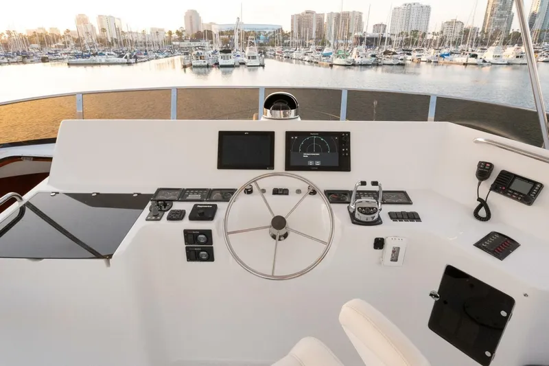 Ok'd By Dad Yacht Photos Pics Helm of 2001 Mikelson 61 Yachtfisher with marina view in background.