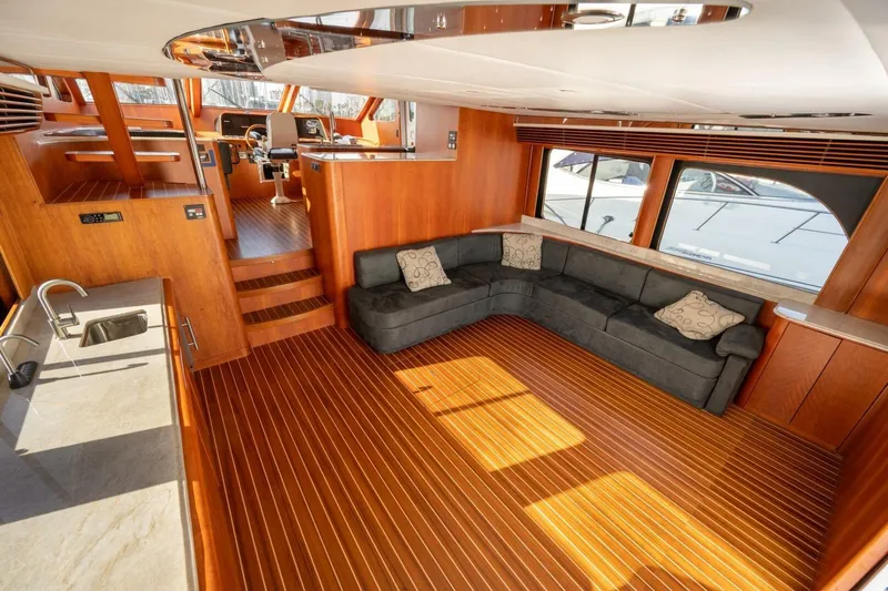 Ok'd By Dad Yacht Photos Pics Luxurious interior of 2001 Mikelson 61 Yachtfisher with wood flooring and plush seating.