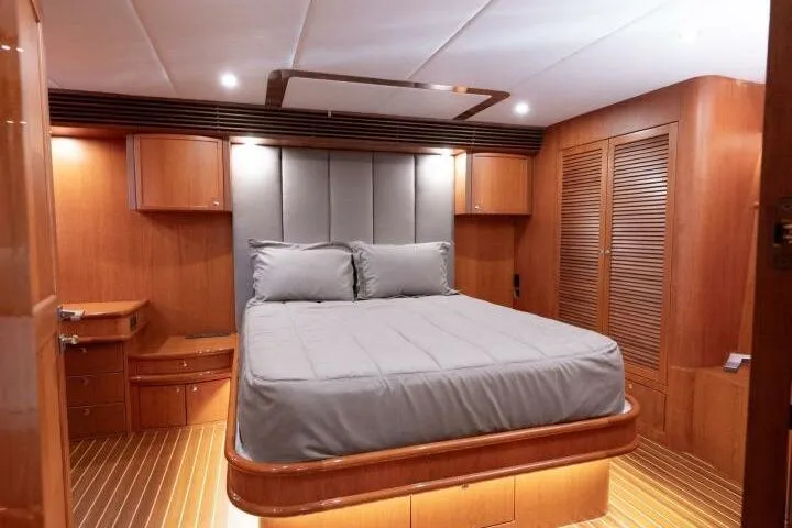 Ok'd By Dad Yacht Photos Pics Luxurious bedroom interior of 2001 Mikelson 61 Yachtfisher with wood accents and modern design.