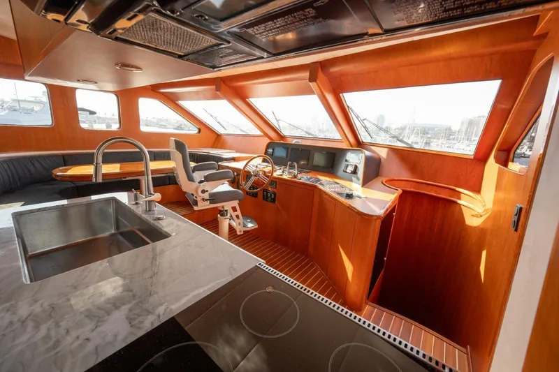 Ok'd By Dad Yacht Photos Pics Luxurious interior of 2001 Mikelson 61 Yachtfisher with modern helm and kitchen area.