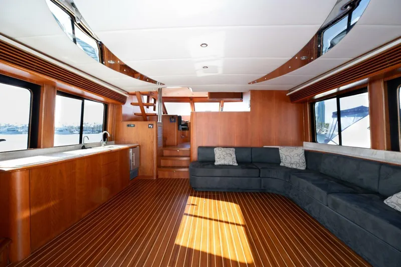 Ok'd By Dad Yacht Photos Pics Luxurious interior of 2001 Mikelson 61 Yachtfisher with wood flooring and spacious seating.