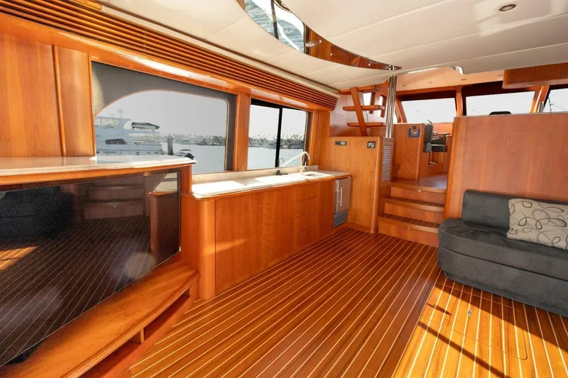 Ok'd By Dad Yacht Photos Pics Luxurious interior of 2001 Mikelson 61 Yachtfisher with wooden flooring and modern amenities.