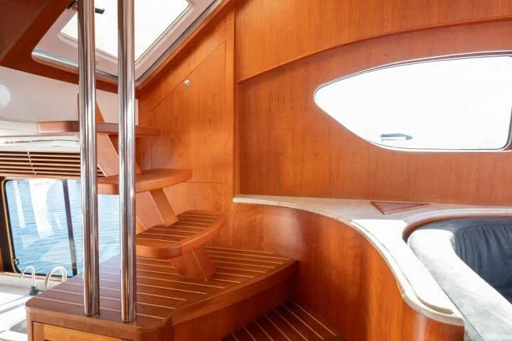 Ok'd By Dad Yacht Photos Pics Interior of 2001 Mikelson 61 Yachtfisher with wooden staircase and elegant design.