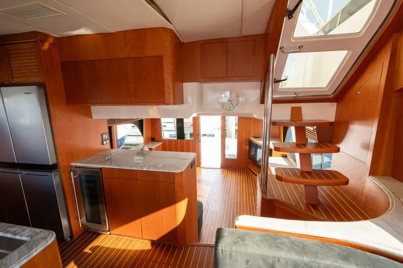 Ok'd By Dad Yacht Photos Pics Luxurious interior of 2001 Mikelson 61 Yachtfisher with wooden finishes and modern kitchen.