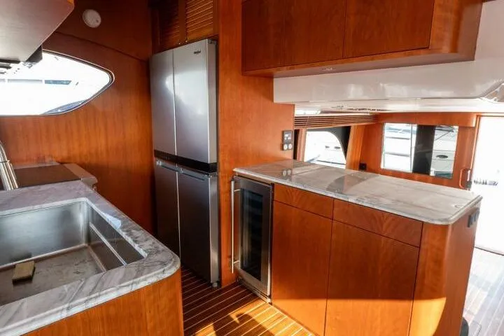 Ok'd By Dad Yacht Photos Pics Luxurious kitchen interior of 2001 Mikelson 61 Yachtfisher with modern appliances and wood finish.