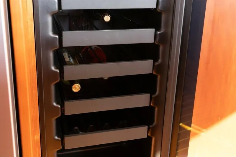 Ok'd By Dad Yacht Photos Pics Wine cooler with bottles inside a 2001 Mikelson 61 Yachtfisher.