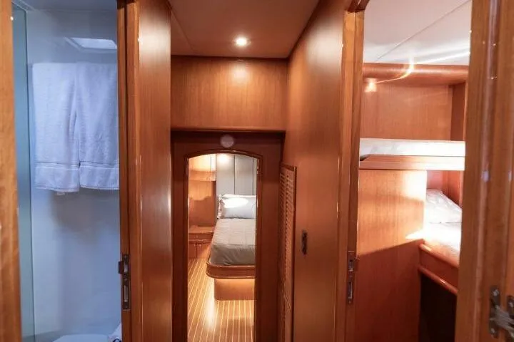 Ok'd By Dad Yacht Photos Pics Luxurious interior of 2001 Mikelson 61 Yachtfisher, featuring cozy wooden cabin and bunk beds.