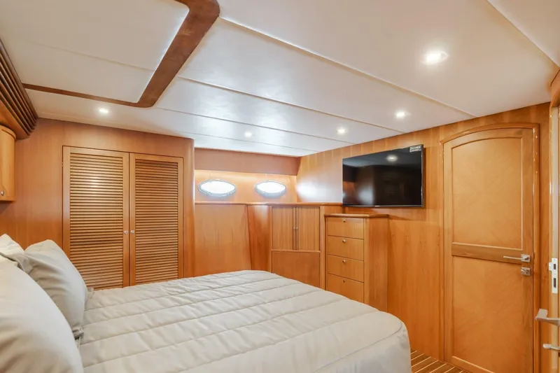 Ok'd By Dad Yacht Photos Pics Luxurious cabin interior of 2001 Mikelson 61 Yachtfisher with wood paneling and modern amenities.