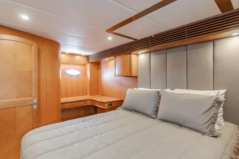 Ok'd By Dad Yacht Photos Pics Luxurious bedroom interior of 2001 Mikelson 61 Yachtfisher with elegant wood finishes and cozy bedding.