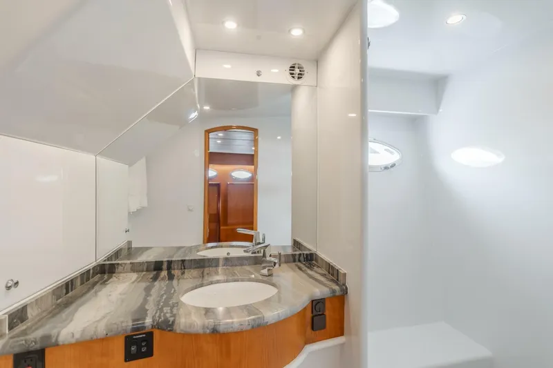 Ok'd By Dad Yacht Photos Pics Luxurious bathroom in 2001 Mikelson 61 Yachtfisher, featuring elegant marble countertop and modern fixtures.