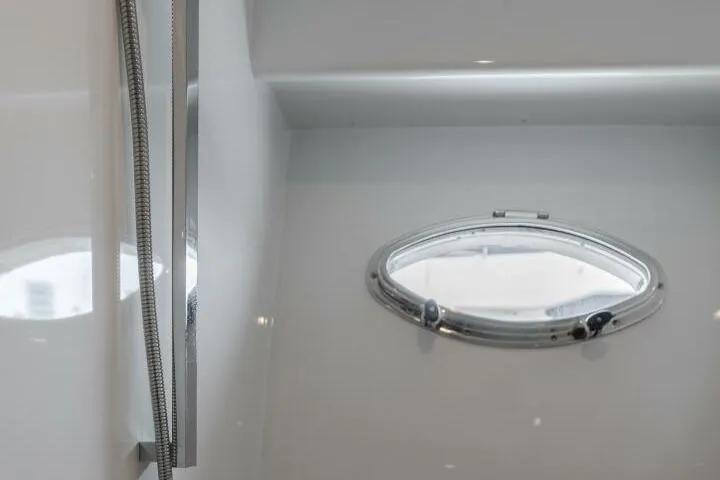 Ok'd By Dad Yacht Photos Pics Porthole window inside 2001 Mikelson 61 Yachtfisher, showcasing sleek interior design.