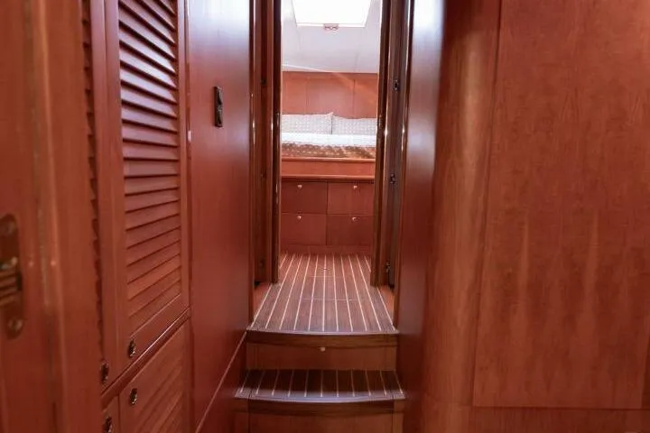 Ok'd By Dad Yacht Photos Pics Interior of 2001 Mikelson 61 Yachtfisher, featuring wooden paneling and cozy cabin entrance.