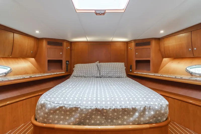 Ok'd By Dad Yacht Photos Pics Luxurious cabin interior of 2001 Mikelson 61 Yachtfisher with wood finish and cozy bedding.