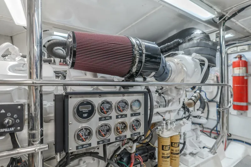 Ok'd By Dad Yacht Photos Pics Engine room of 2001 Mikelson 61 Yachtfisher with gauges and filters visible.