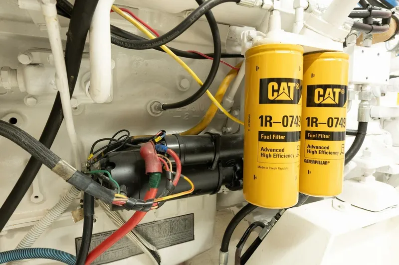 Ok'd By Dad Yacht Photos Pics Engine compartment of 2001 Mikelson 61 Yachtfisher with CAT fuel filters and wiring.
